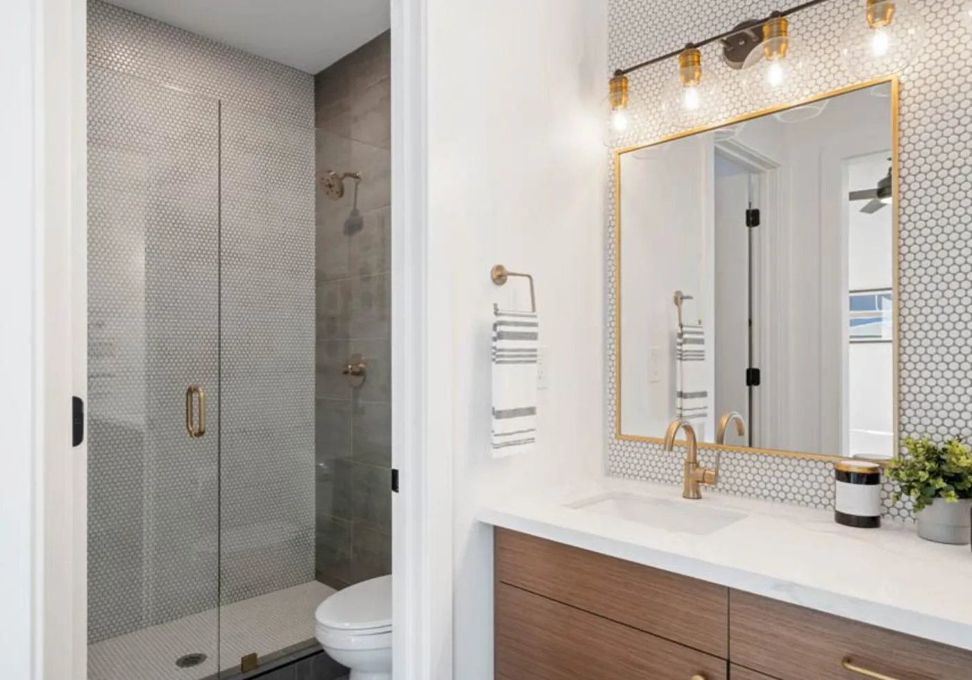 Custom tiled walk-in shower with glass panel