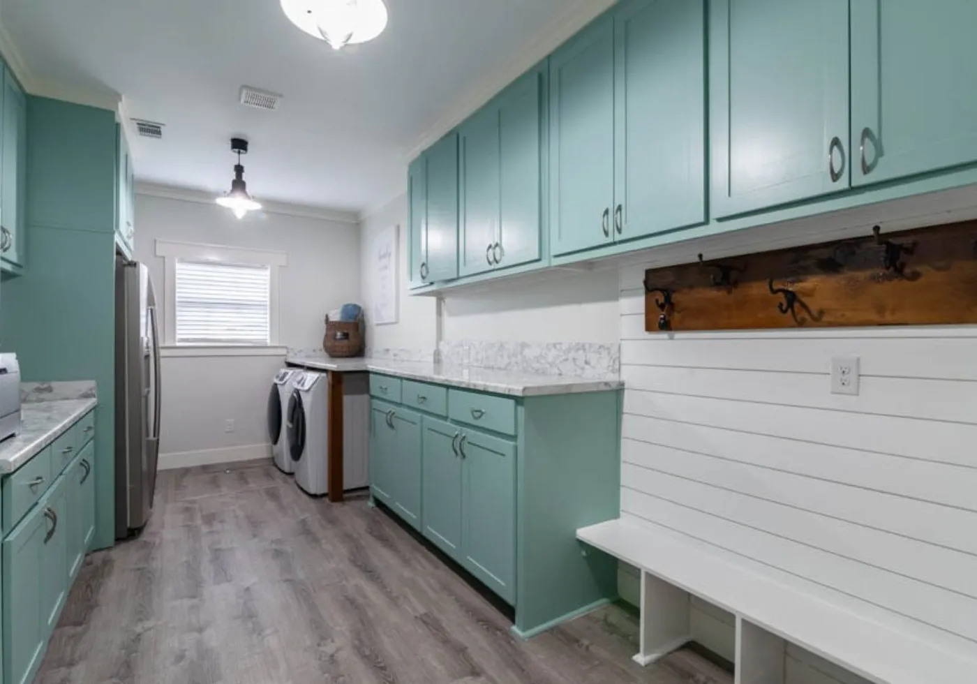 Laundry room with matching cabinetry and counter
