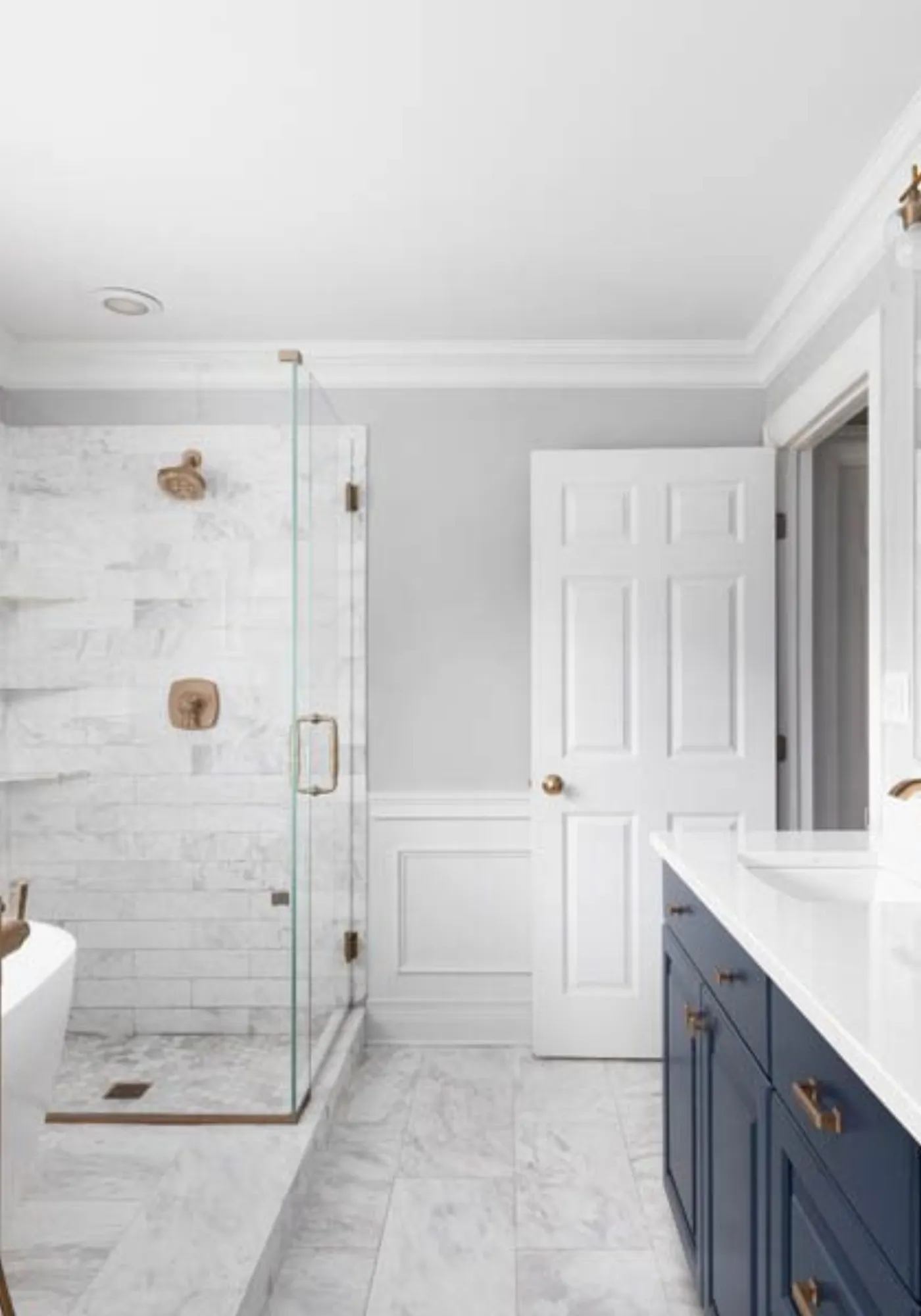 Renovated bathroom with a tiled walk-in shower and new vanity
